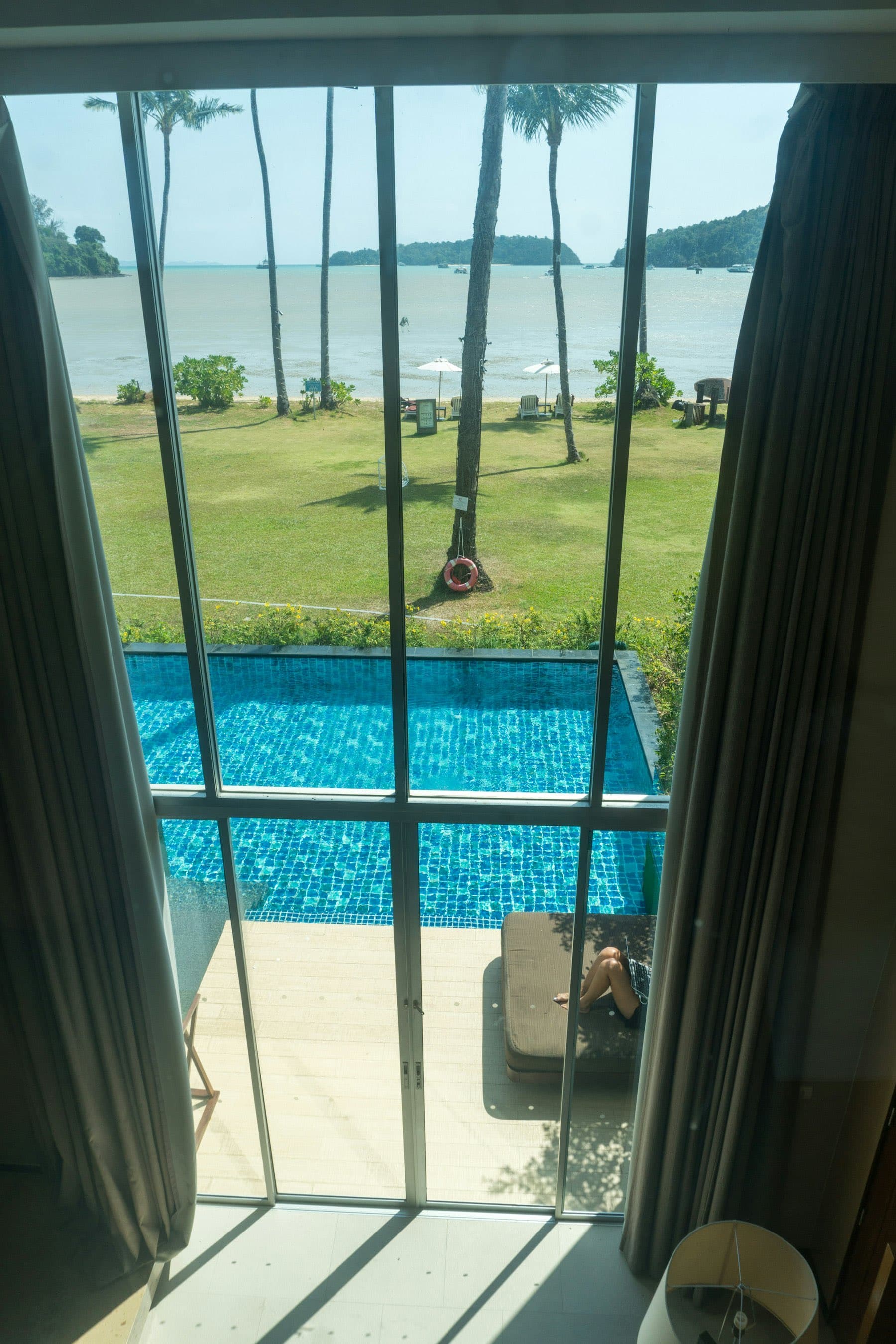 Pool seen through the ground-floor window wall
